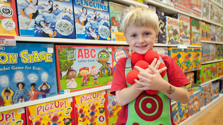 boy with red balls in learning express toy store